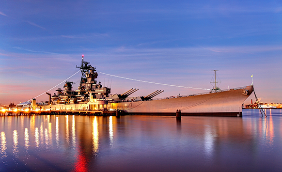 USS New Jersey battleship at sunset