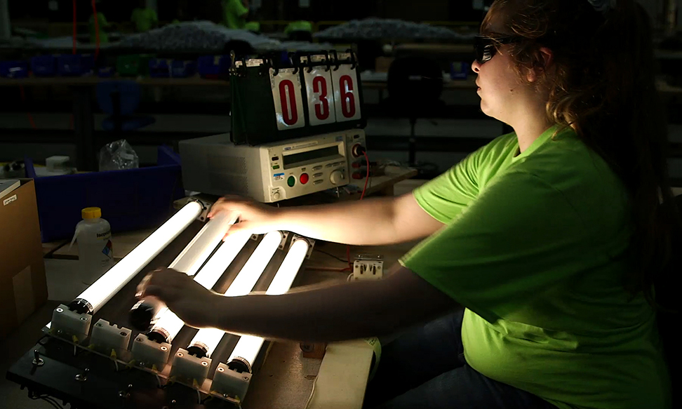 production worker performing light up test on M1